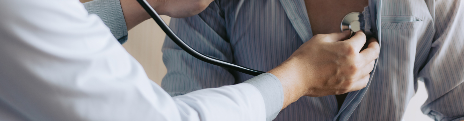 Asian doctor is using a stethoscope listen to the heartbeat of the elderly patient